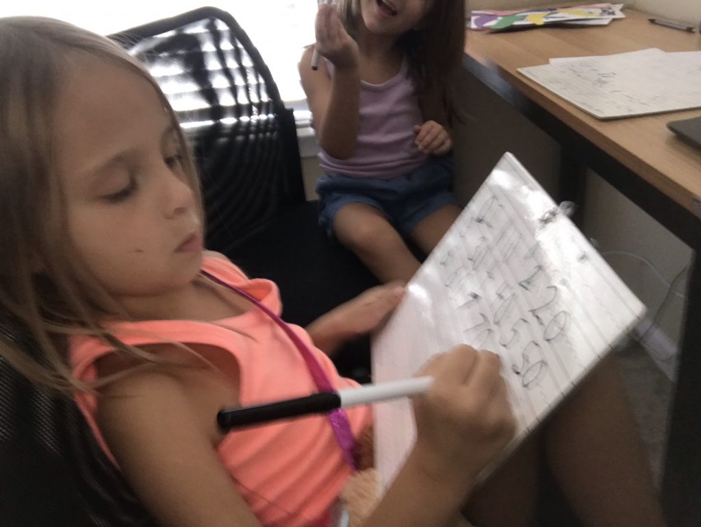 My 6-year-old, working hard on writing her numbers during a serious homeschool moment.