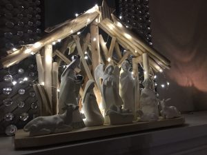 A nativity scene sitting on the mantle above a fireplace