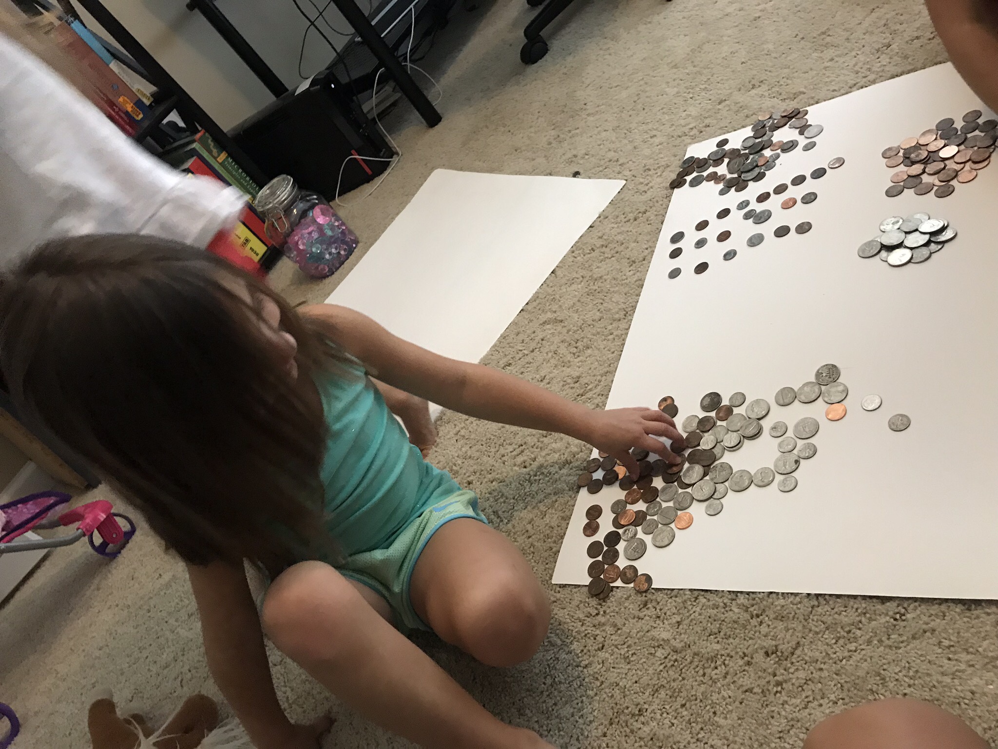 first grader doing math by counting coins