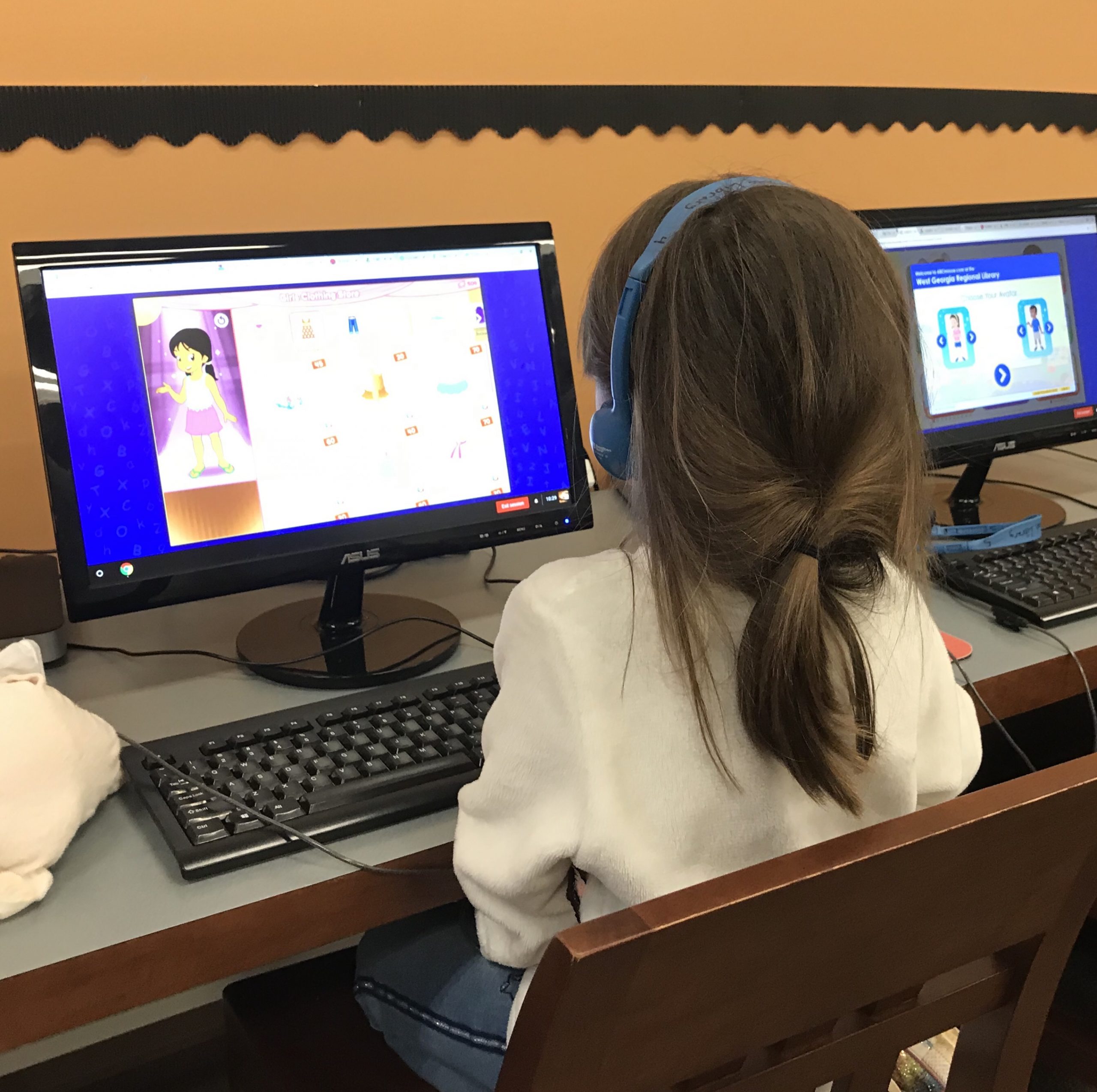 homeschool child sitting in front of library computer