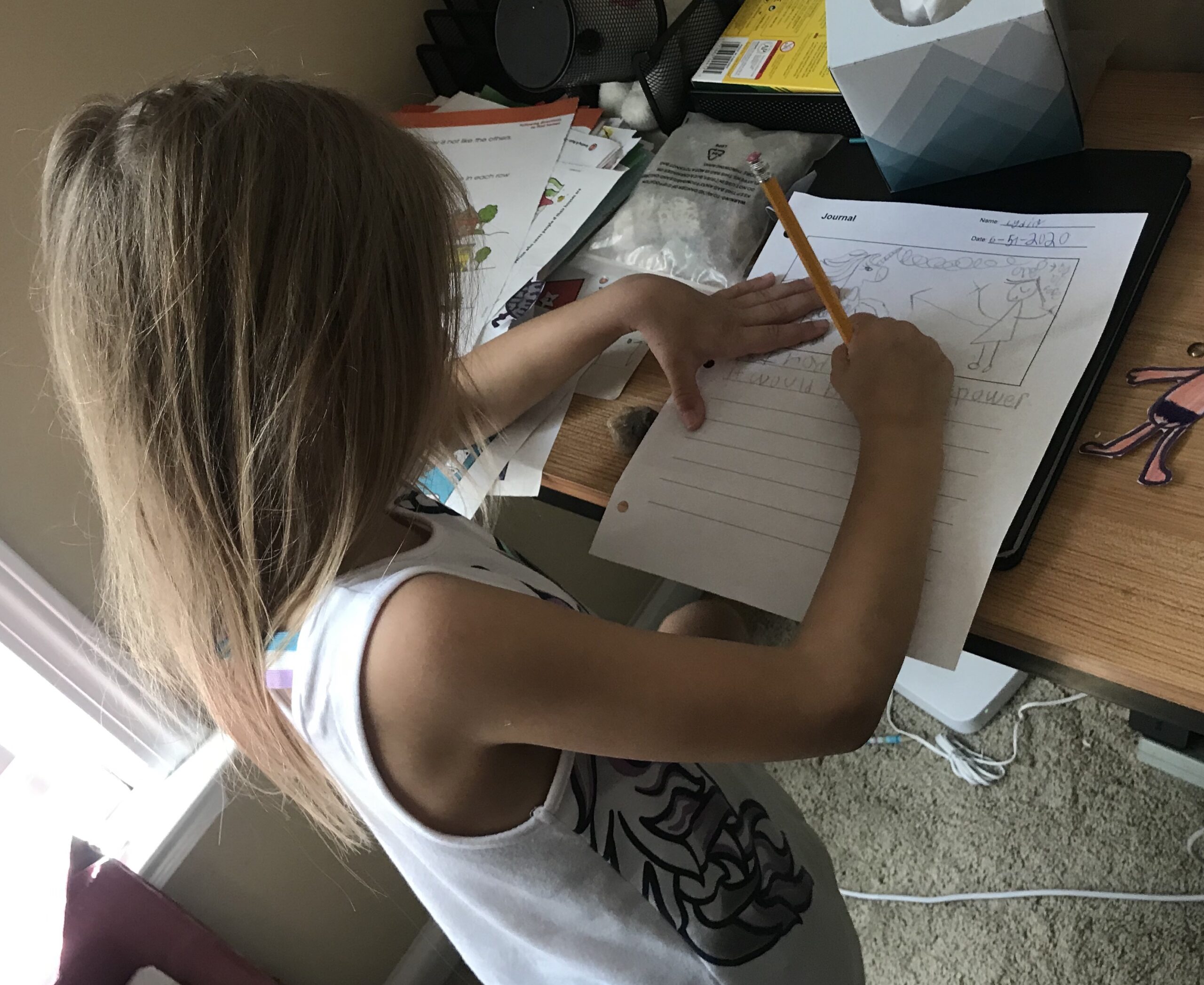 second grade home school child writing in a journal